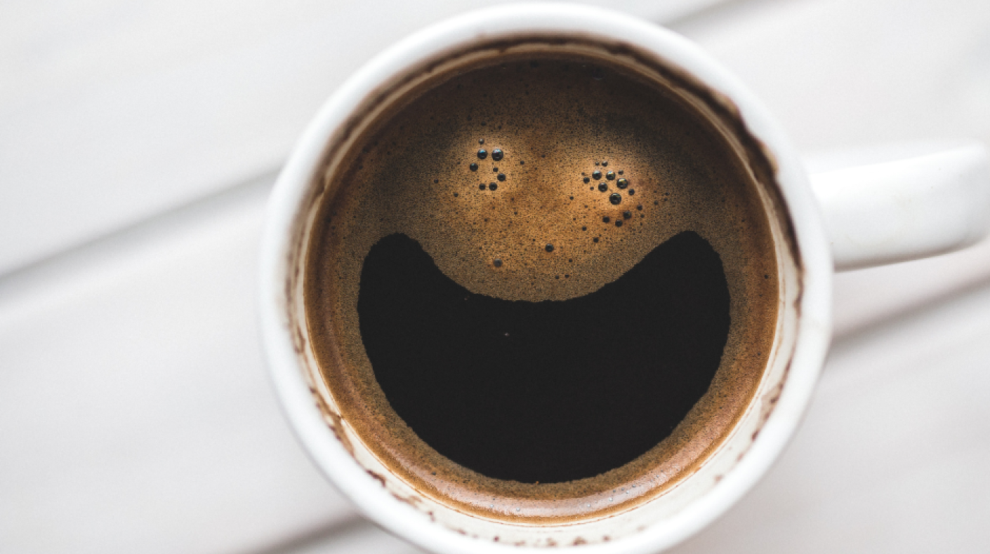 Coffee mug with a smiling face made out of the bubbles