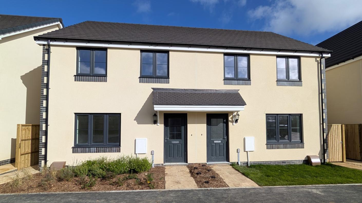 A photograph of 2 semi detached new build homes