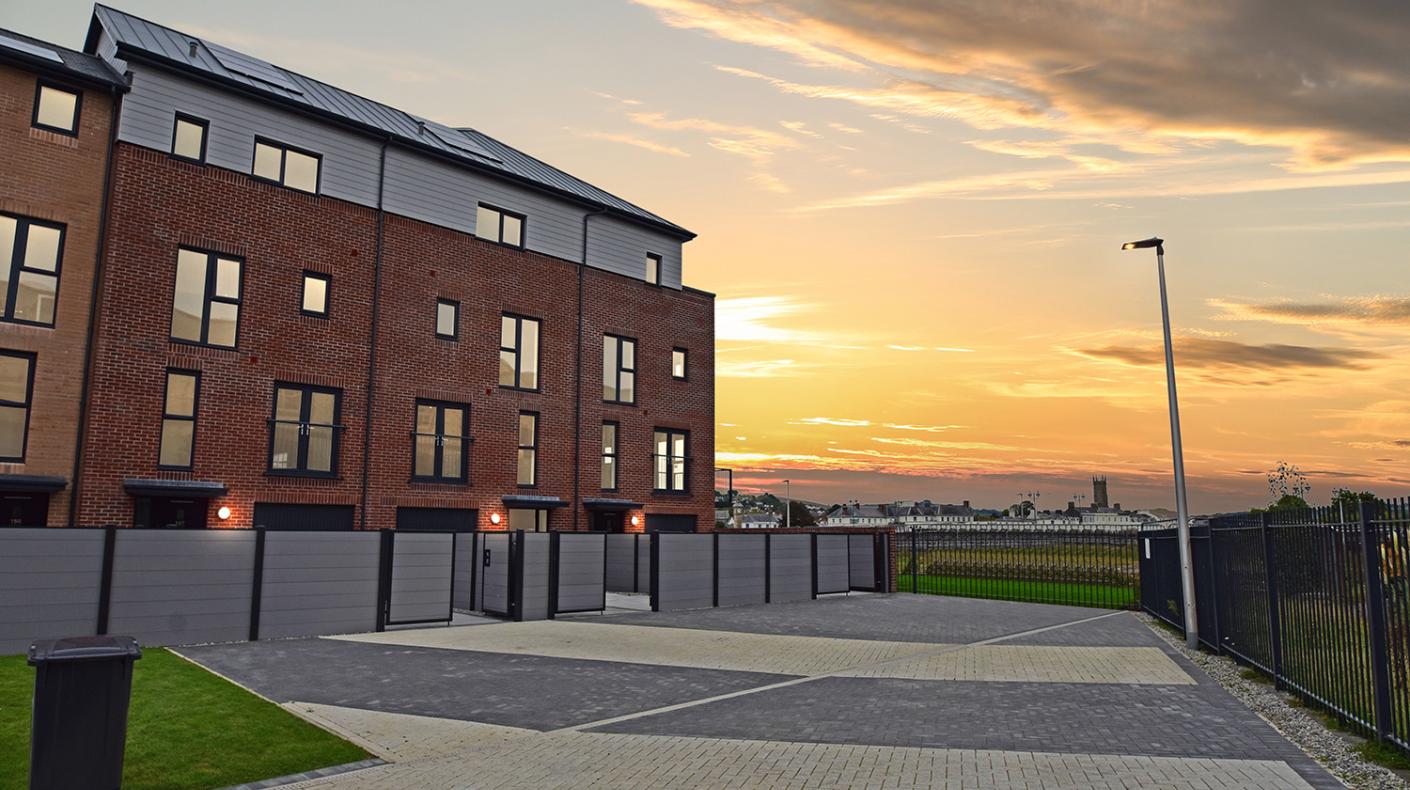 Three terraced townhouses at sunset