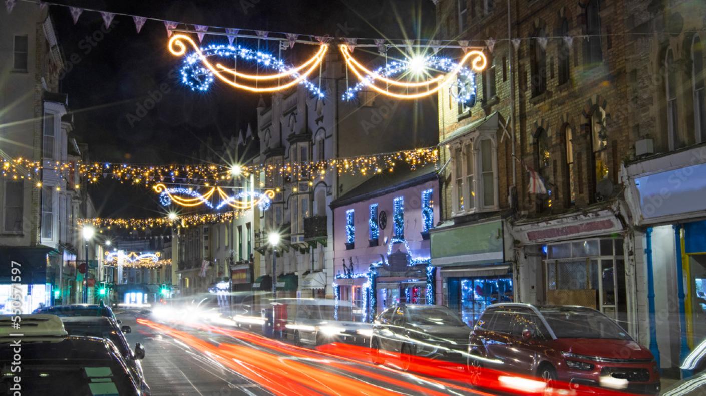 A street in Ilfracombe at night with Christmas lights strung between the buildings