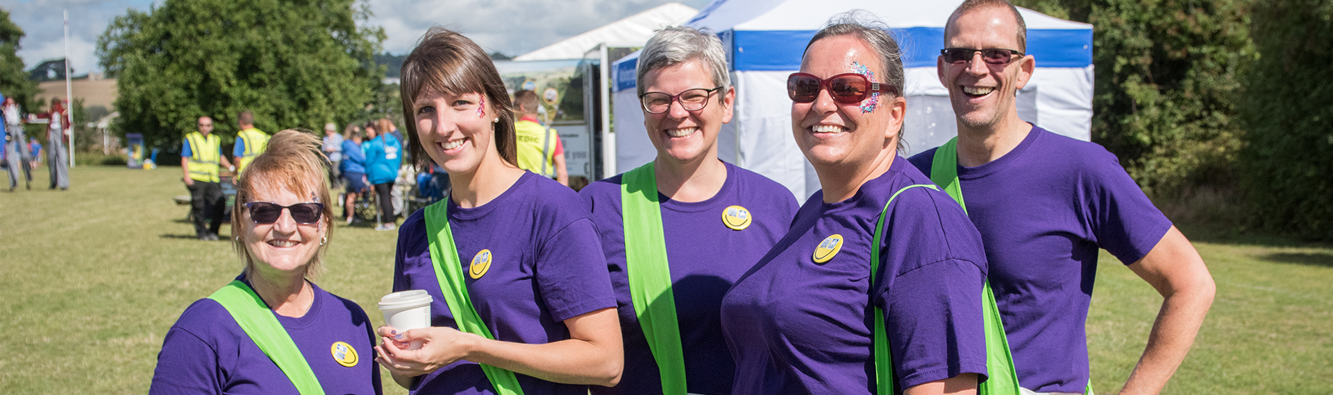 Our people; Team NDH at Customer Summer Fayre; purple tee shirts and green sashes