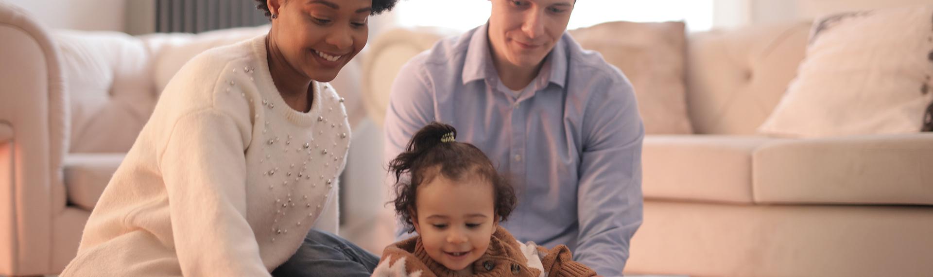 Rent Payment; man, woman and toddler sitting on the floor