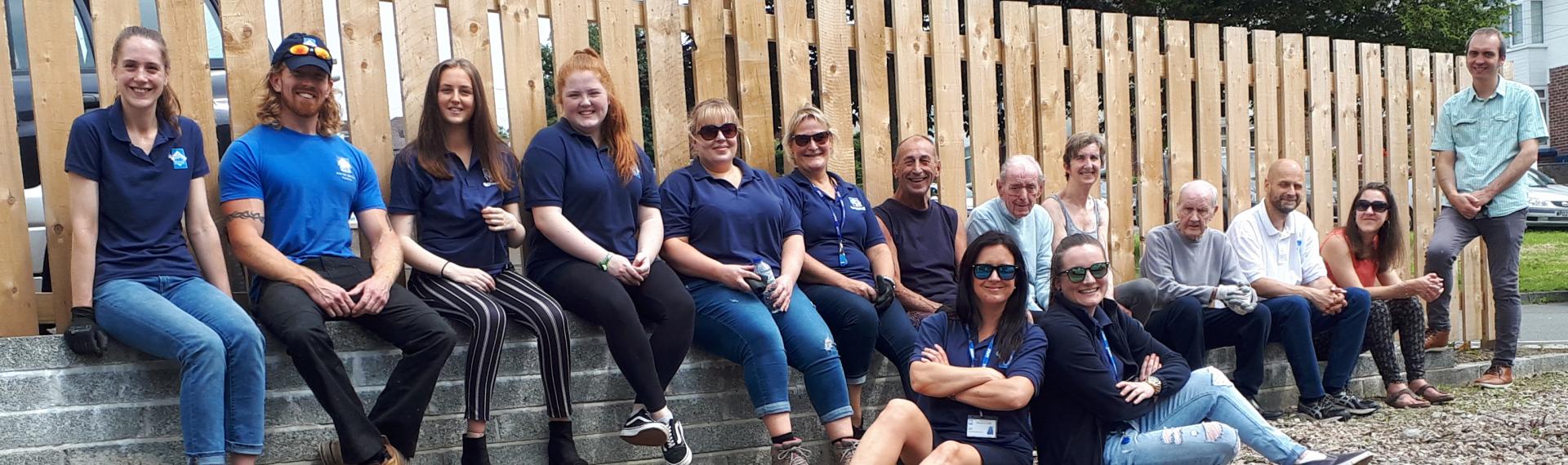 Estate Clean Up Day; team sitting on a wall
