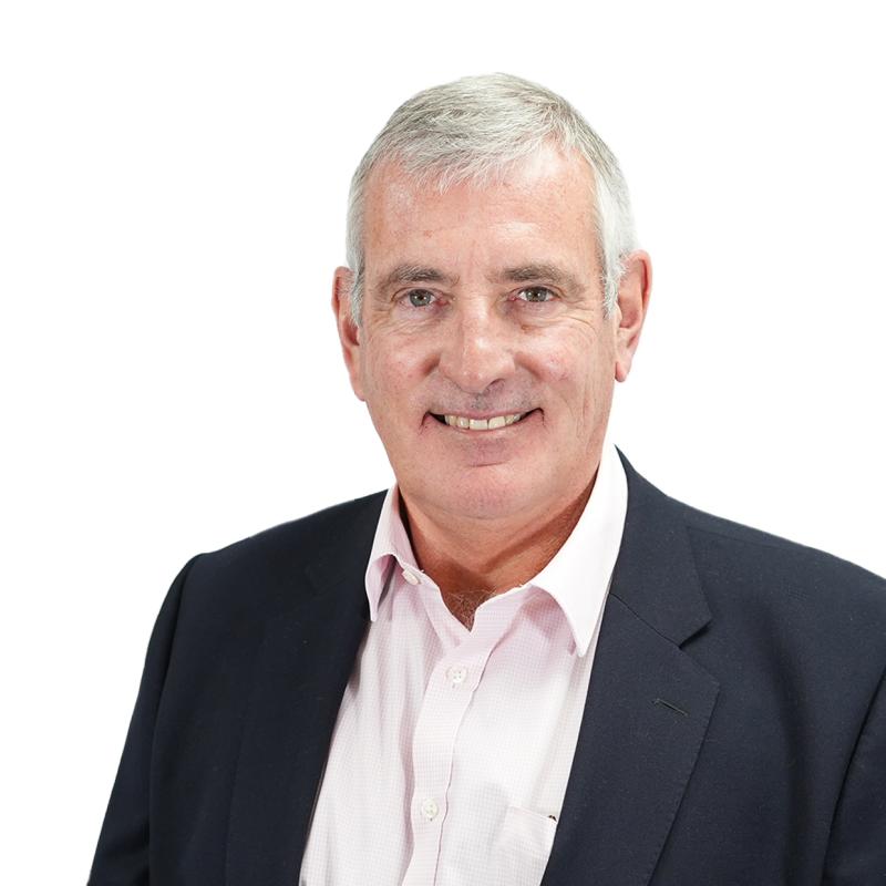 Colin Dennis, Chair of the Board; head and shoulder grey haired man in pink shirt